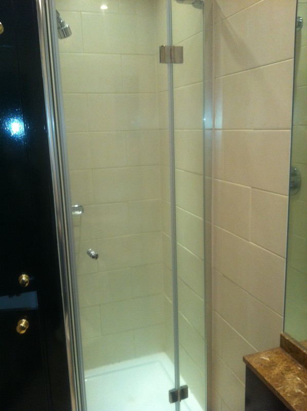 Frameless glass shower enclosure with chrome fittings in Neasden