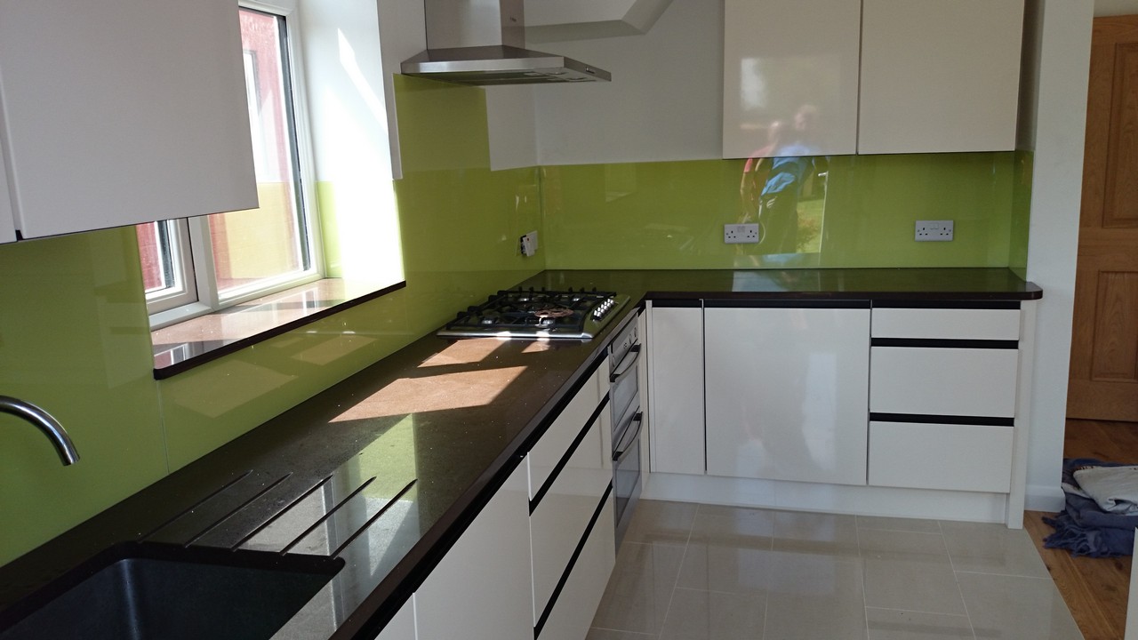 Lime green glass kitchen splashback installed by Neasden glaziers
