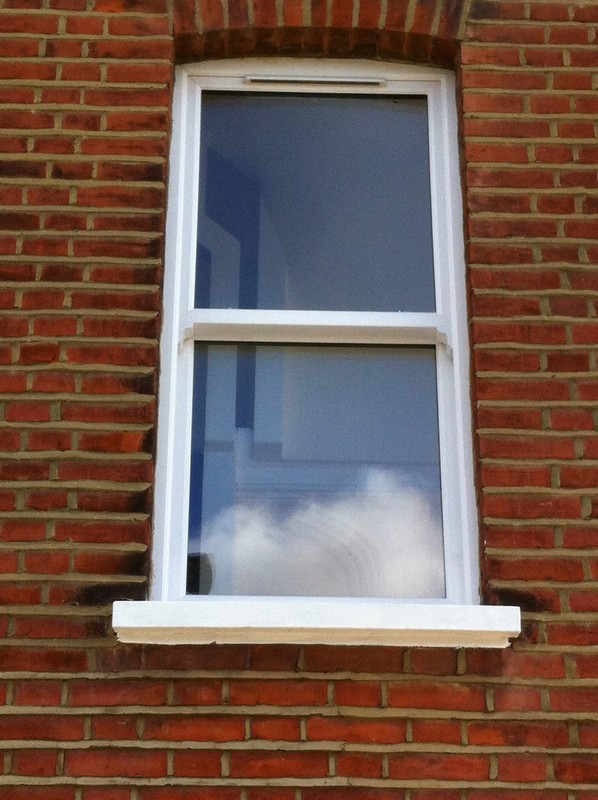 uPVC sash window on Victorian red brick house in Neasden